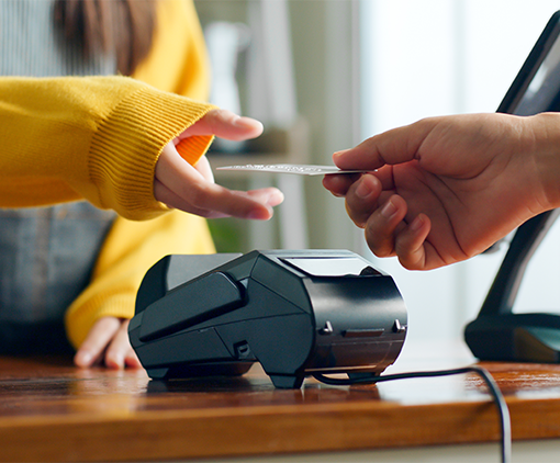 Woman holding her car to a payment terminal